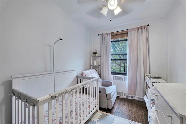 19 Rockledge Rd Unit 1A, Hartsdale, NY 10530 - bedroom featuring dark wood finished floors, radiator heating unit, ceiling fan, and a nursery area