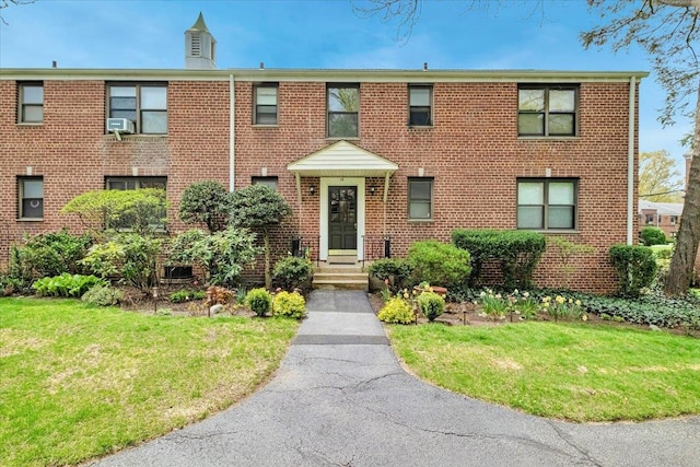 19 Rockledge Rd Unit 1A, Hartsdale, NY 10530 - view of property with brick siding, a front lawn, and cooling unit