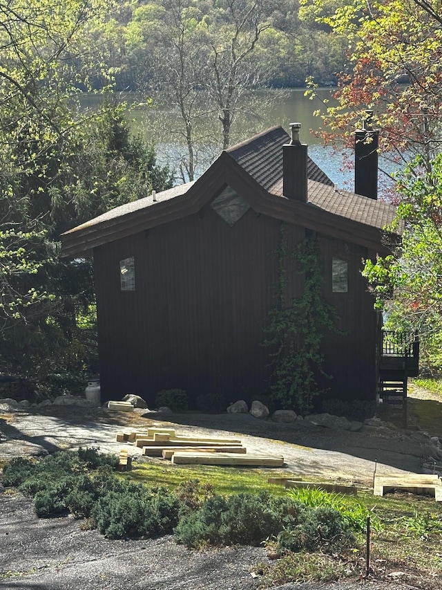view of side of home with a chimney