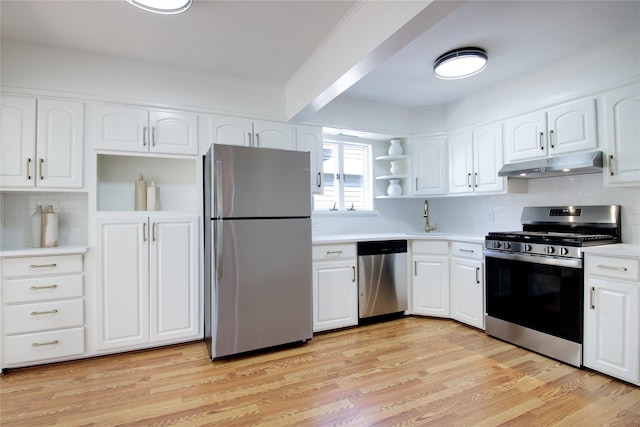 kitchen with stainless steel appliances, open shelves, under cabinet range hood, backsplash, and a sink