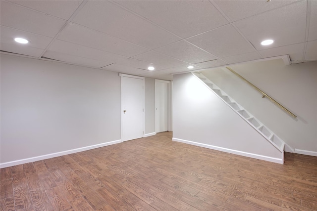 finished below grade area with wood finished floors and baseboards