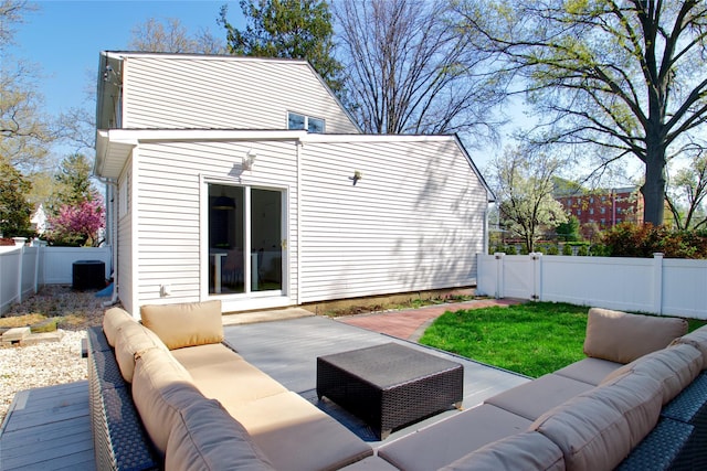 exterior space featuring outdoor lounge area, a patio, a fenced backyard, and central AC unit