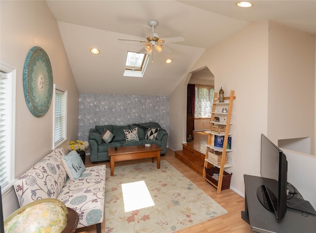 130 E Main St, Washingtonville, NY 10992 - living room with vaulted ceiling with skylight, a ceiling fan, light wood-type flooring, baseboards, and an accent wall