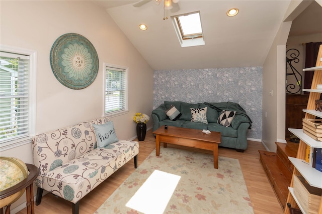 130 E Main St, Washingtonville, NY 10992 - living room with vaulted ceiling with skylight, ceiling fan, wood finished floors, an accent wall, and recessed lighting
