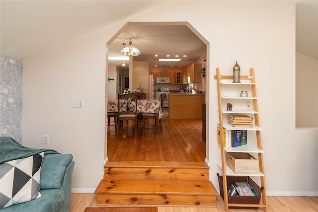 130 E Main St, Washingtonville, NY 10992 - interior space featuring arched walkways, baseboards, an inviting chandelier, and wood finished floors