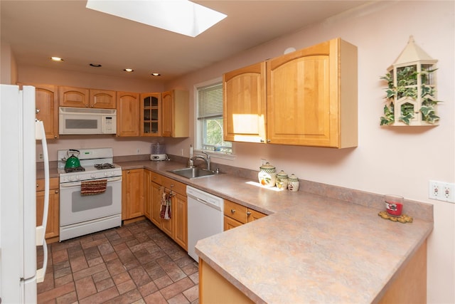 130 E Main St, Washingtonville, NY 10992 - kitchen featuring a sink, white appliances, a peninsula, recessed lighting, and a skylight
