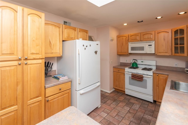 130 E Main St, Washingtonville, NY 10992 - kitchen featuring glass insert cabinets, light countertops, brick patterned floor, and white appliances