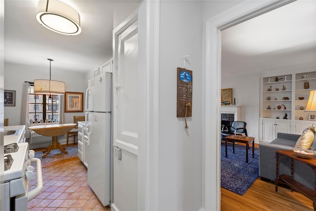 hall featuring light tile patterned floors