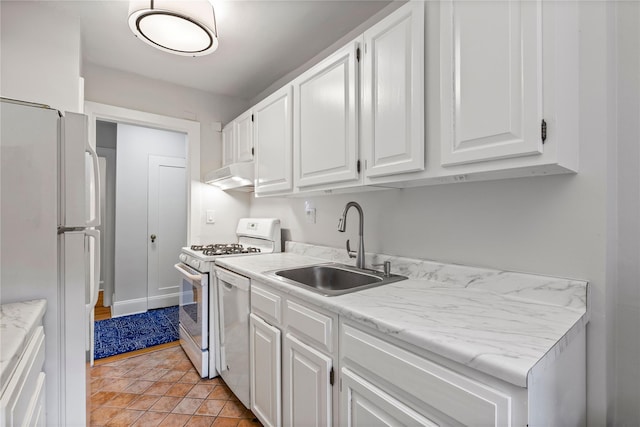kitchen featuring white appliances, white cabinets, under cabinet range hood, and a sink