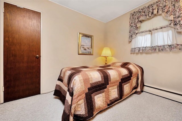bedroom with baseboards, a baseboard heating unit, and carpet