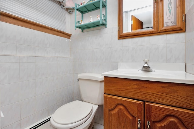 bathroom with vanity, toilet, tile walls, decorative backsplash, and a baseboard heating unit