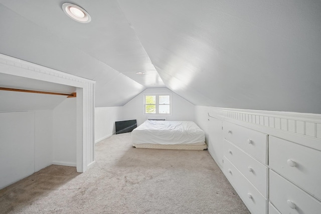 bedroom featuring carpet and vaulted ceiling
