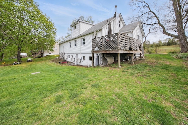 view of side of property featuring a lawn and a deck
