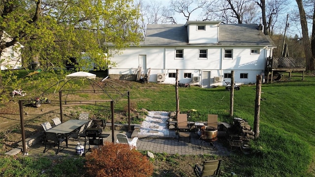back of property with a patio and a yard
