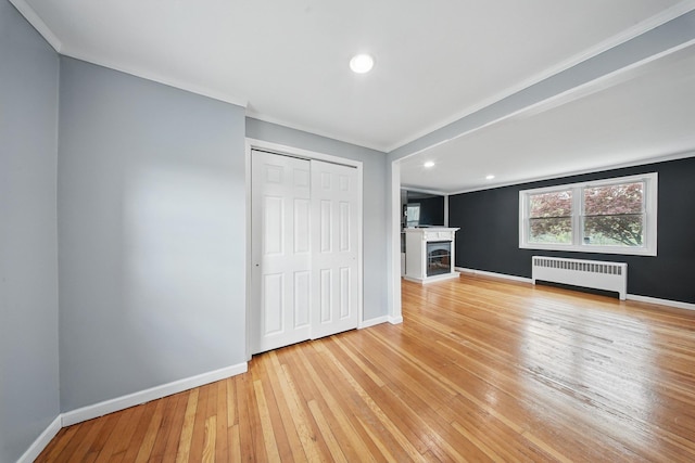 83 Woodcock Mtn Rd, Washingtonville, NY 10992 - unfurnished living room with radiator, light wood-style floors, and baseboards