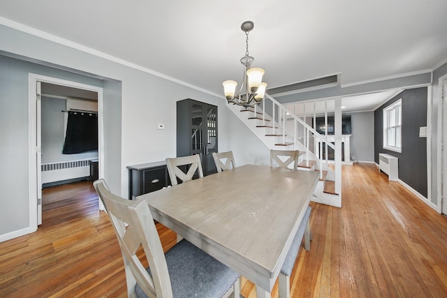 83 Woodcock Mtn Rd, Washingtonville, NY 10992 - dining room featuring stairs, radiator, an inviting chandelier, baseboards, and light wood-style floors