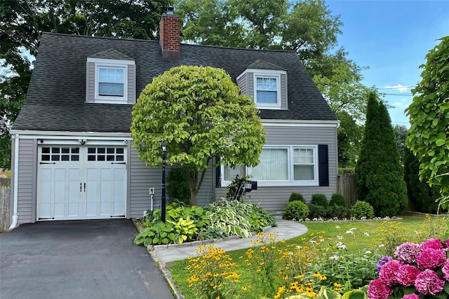 69 Howard Ave, Eastchester, NY 10709 - view of front of house with a garage, a chimney, and asphalt driveway