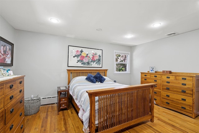 bedroom featuring visible vents, recessed lighting, light wood-style flooring, and baseboard heating