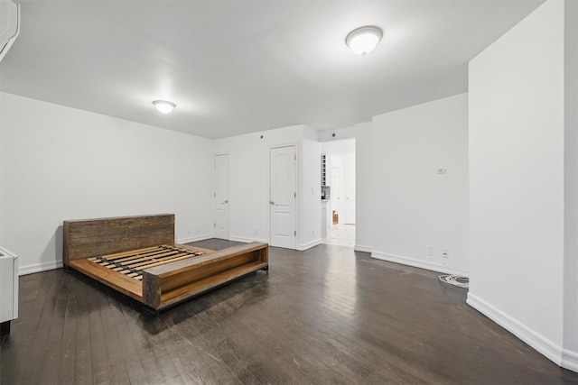 bedroom with baseboards and wood finished floors