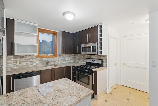 kitchen with a sink, appliances with stainless steel finishes, tasteful backsplash, and open shelves