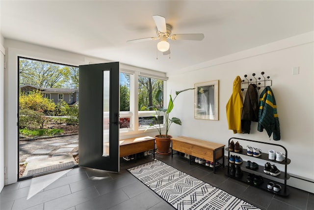 mudroom with tile patterned flooring, a ceiling fan, and a wealth of natural light
