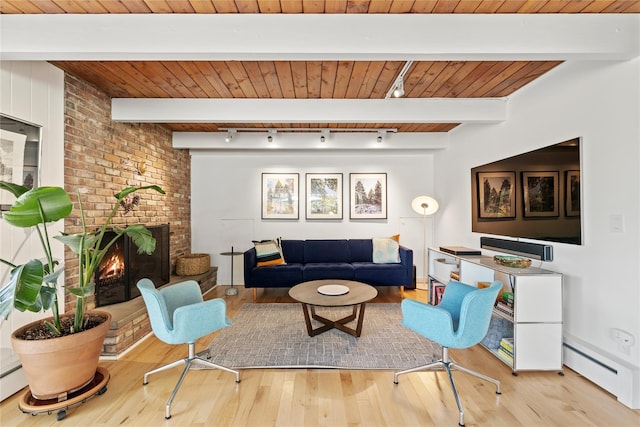 living room featuring wood ceiling, a baseboard heating unit, and wood finished floors