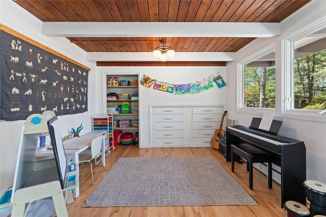 playroom featuring wood ceiling, beamed ceiling, a baseboard heating unit, and wood finished floors