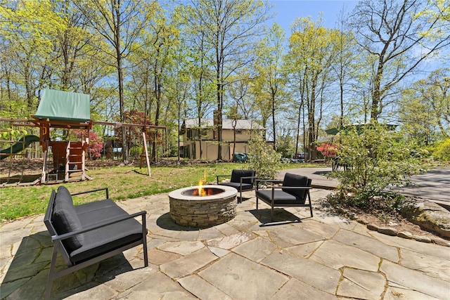 view of patio / terrace with a fire pit and a playground