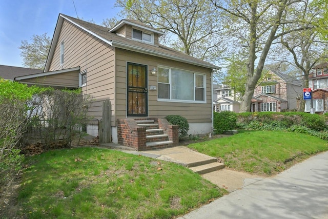 bungalow-style house with a front yard