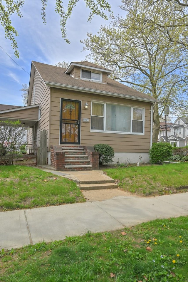 bungalow-style house with a front yard