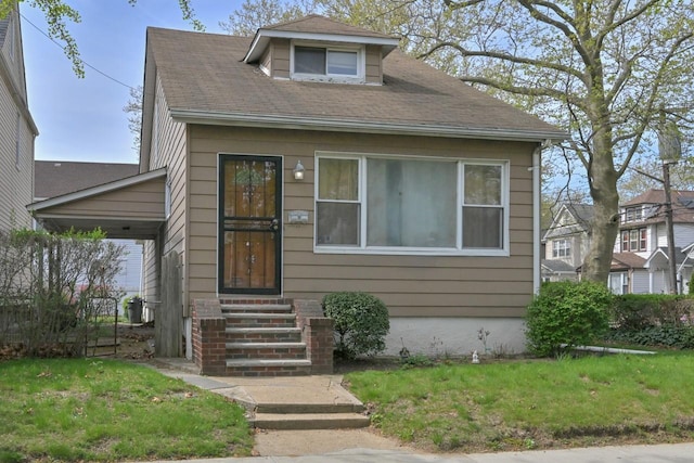 view of front of house with entry steps and a front lawn