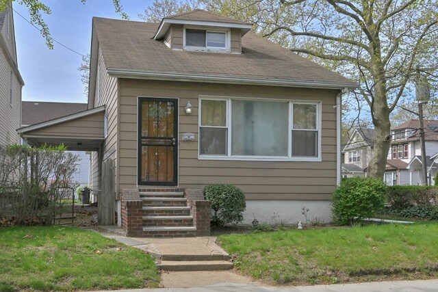 114-02 Sutter Ave, South Ozone Park, NY 11420 - view of front of house with entry steps and a front lawn