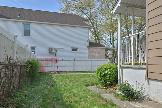 view of yard with ac unit and fence