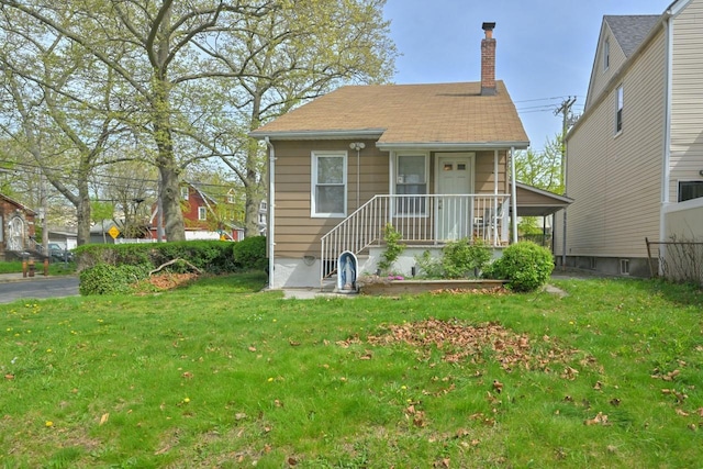 bungalow-style house featuring a chimney and a front lawn