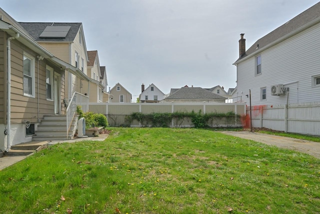 view of yard with a fenced backyard and a residential view