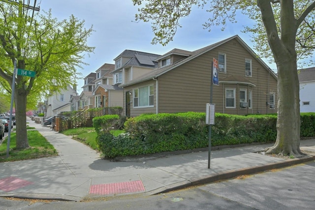 view of home's exterior with a residential view and cooling unit