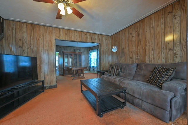 carpeted living room with wooden walls and a ceiling fan