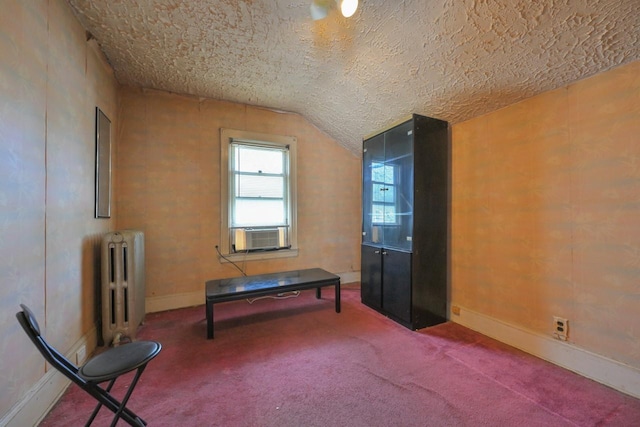 interior space featuring carpet, lofted ceiling, radiator heating unit, and cooling unit