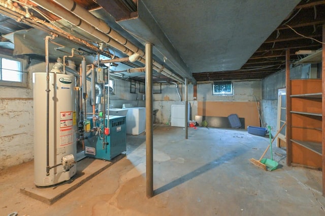 below grade area with a heating unit, washing machine and dryer, and gas water heater