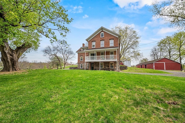 353 Berea Rd, Walden, NY 12586 - back of house with a lawn, brick siding, and a detached garage