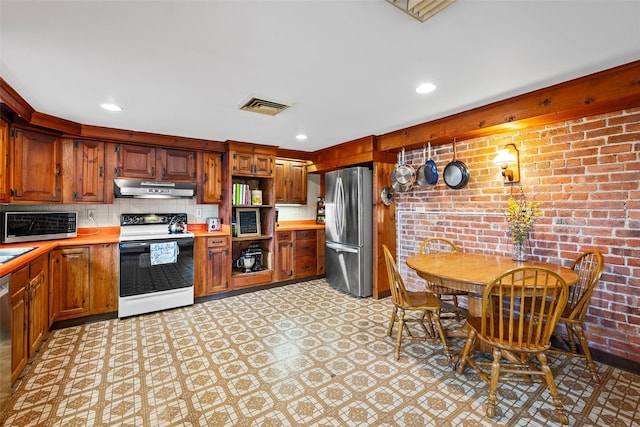 353 Berea Rd, Walden, NY 12586 - kitchen featuring appliances with stainless steel finishes, light countertops, light floors, under cabinet range hood, and visible vents
