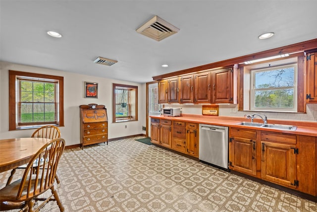 353 Berea Rd, Walden, NY 12586 - kitchen with visible vents, stainless steel dishwasher, a sink, light countertops, and baseboards