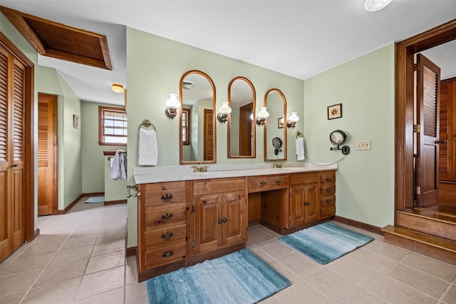 353 Berea Rd, Walden, NY 12586 - bathroom featuring a closet, tile patterned flooring, double vanity, baseboards, and a sink