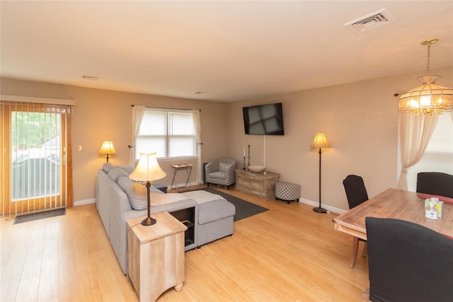 207 Cornwall Meadows Ln, Patterson, NY 12563 - living area featuring light wood-type flooring, plenty of natural light, baseboards, and a chandelier