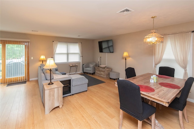 207 Cornwall Meadows Ln, Patterson, NY 12563 - dining area featuring light wood finished floors, plenty of natural light, a chandelier, and baseboards