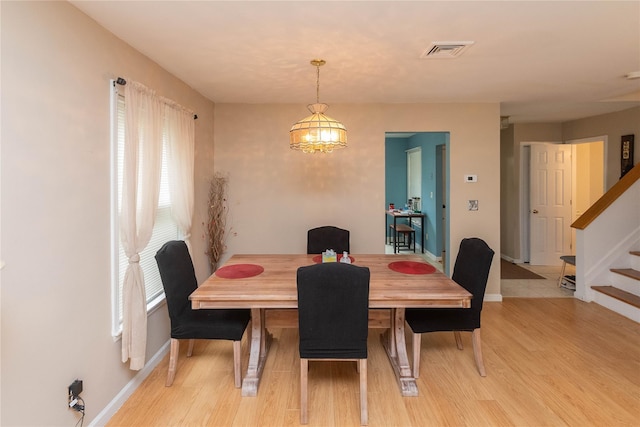 207 Cornwall Meadows Ln, Patterson, NY 12563 - dining space with stairs, baseboards, light wood finished floors, and a chandelier