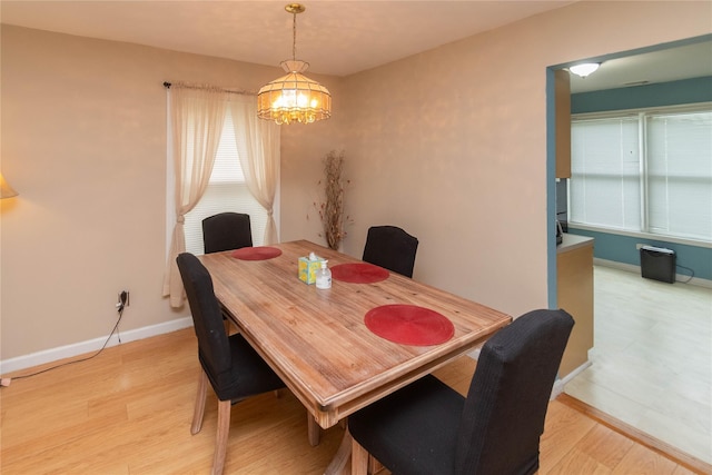 207 Cornwall Meadows Ln, Patterson, NY 12563 - dining room with a chandelier, light wood finished floors, baseboards, and plenty of natural light