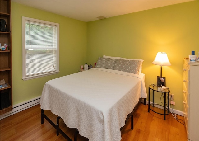 207 Cornwall Meadows Ln, Patterson, NY 12563 - bedroom featuring wood finished floors, a baseboard heating unit, and baseboards