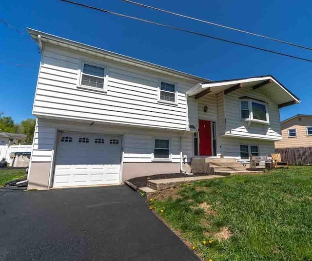 148 Chandler Ln, Montgomery, NY 12549 - split foyer home with a front lawn, driveway, fence, and a garage