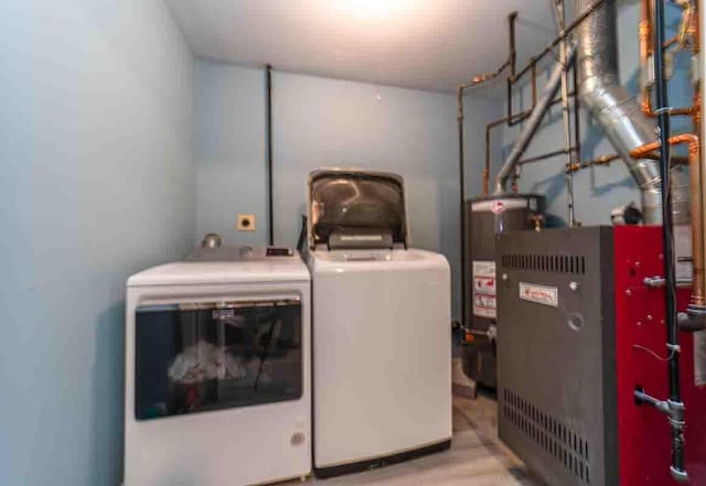 148 Chandler Ln, Montgomery, NY 12549 - laundry room with washing machine and clothes dryer, gas water heater, and laundry area